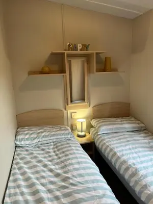 two beds sitting next to each other in a room at Marina Retreat in Haverigg