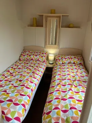 two beds sitting next to each other in a room at Marina Retreat in Haverigg