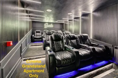 a cinema room with leather chairs and a sign that says cinema grandstand appointment only at Swish Luxury Holiday Apartments in Blackpool