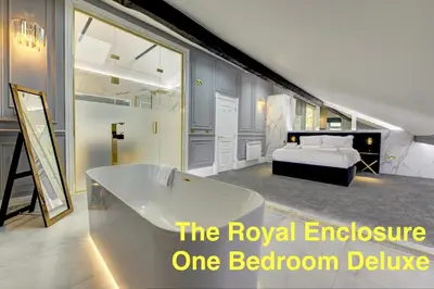 a bedroom with a bed and a bath tub at Swish Luxury Holiday Apartments in Blackpool