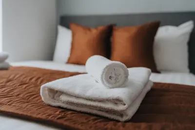 a pile of towels sitting on top of a bed at Vichy - Strathcona Suites, 3 beds houses in Wavertree in Liverpool