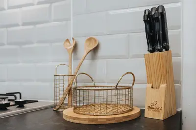 a kitchen counter with wooden spoons and knives at Vichy - Strathcona Suites, 3 beds houses in Wavertree in Liverpool