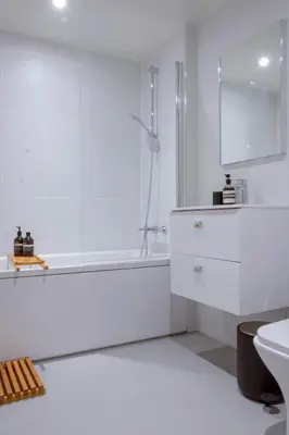 a white bathroom with a tub and a sink at LIVINGWAY Roco in Liverpool