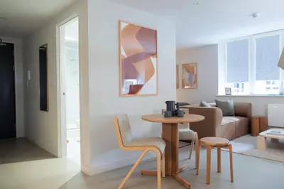 a living room with a table and chairs and a couch at LIVINGWAY Roco in Liverpool