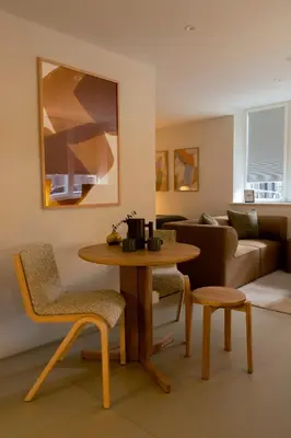 a living room with a table and chairs and a couch at LIVINGWAY Roco in Liverpool