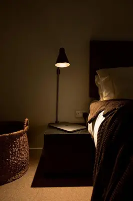 a bedroom with a bed with a lamp next to it at LIVINGWAY Roco in Liverpool