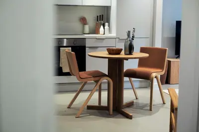 a kitchen with a wooden table and two chairs at LIVINGWAY Roco in Liverpool