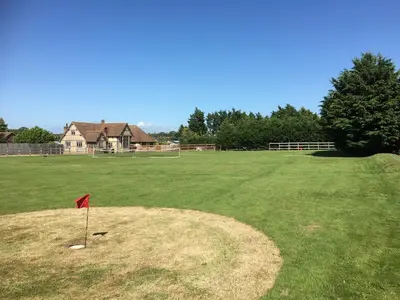 a red flag in the middle of a large field at FLETCHERS HALL COVERED POOL Heated in Freckleton