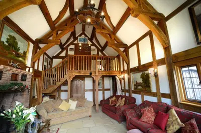 a large living room with a wooden ceiling at FLETCHERS HALL COVERED POOL Heated in Freckleton