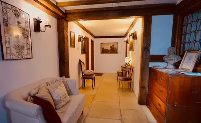 a living room with a couch and a dresser at FLETCHERS HALL COVERED POOL Heated in Freckleton