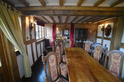a dining room with a wooden table and chairs at FLETCHERS HALL COVERED POOL Heated in Freckleton