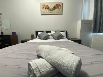 a bedroom with a bed with two towels on it at BEST CHOICE - Hotel Royal in Blackburn