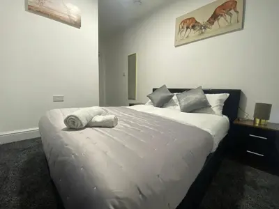 a bedroom with a large white bed with towels on it at BEST CHOICE - Hotel Royal in Blackburn