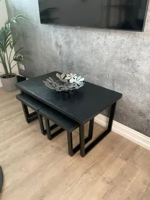 a black table with a bowl of flowers on it at The Cottage in Saint Annes on the Sea