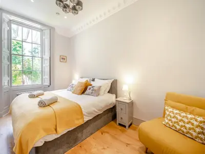 a bedroom with a bed and a window at Mishmash in Arnside