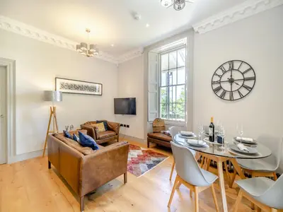 a living room with a table and a couch at Mishmash in Arnside