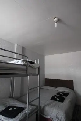 two bunk beds in a room with a ceiling at Jesmond International Hotel in Blackpool
