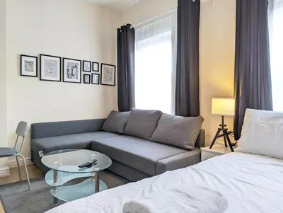 a living room with a couch and a bed at Lovely Studio in Anfield Near Centre Free Parking in Liverpool