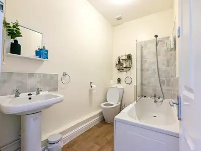 a white bathroom with a sink and a toilet at Lovely Studio in Anfield Near Centre Free Parking in Liverpool