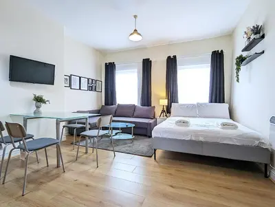 a bedroom with a bed and a table and a couch at Lovely Studio in Anfield Near Centre Free Parking in Liverpool