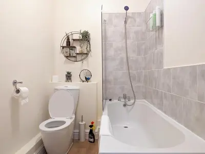 a bathroom with a toilet and a bath tub at Lovely Studio in Anfield Near Centre Free Parking in Liverpool