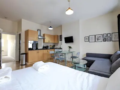 a room with a bed and a kitchen and a living room at Lovely Studio in Anfield Near Centre Free Parking in Liverpool