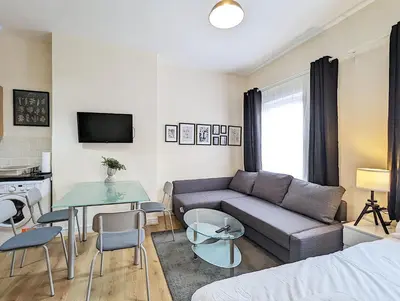 a living room with a couch and a table at Lovely Studio in Anfield Near Centre Free Parking in Liverpool