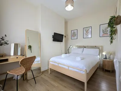 a bedroom with a bed and a desk and a tv at Guest Rooms in Anfiled Near Stadium, Free Parking in Liverpool