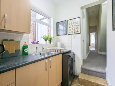 a kitchen with a sink and a washing machine at Guest Rooms in Anfiled Near Stadium, Free Parking in Liverpool