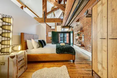 a bedroom with a bed and a brick wall at Host & Stay - Bands Warehouse VI in Liverpool