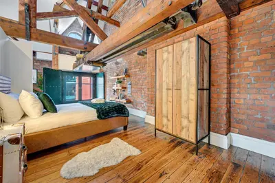 a brick room with a bed and a brick wall at Host & Stay - Bands Warehouse VI in Liverpool