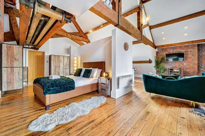 a master bedroom with a bed and a bathtub at Host & Stay - Bands Warehouse VI in Liverpool