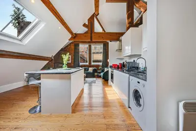 a kitchen with white appliances and wooden ceilings at Host & Stay - Bands Warehouse VI in Liverpool