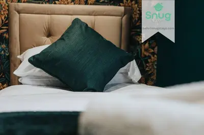a green pillow sitting on top of a bed at Fairfield house - 4 bedroom, 8 beds, free Wi-Fi, free parking in Liverpool