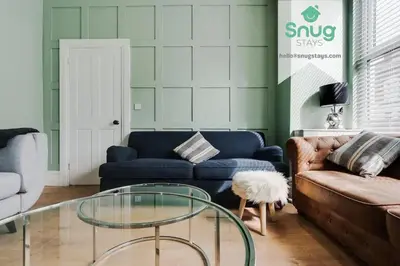 a living room with a couch and a glass table at Fairfield house - 4 bedroom, 8 beds, free Wi-Fi, free parking in Liverpool