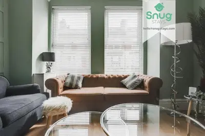 a living room with a couch and a glass table at Fairfield house - 4 bedroom, 8 beds, free Wi-Fi, free parking in Liverpool