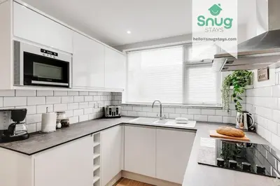 a white kitchen with a sink and a microwave at Fairfield house - 4 bedroom, 8 beds, free Wi-Fi, free parking in Liverpool