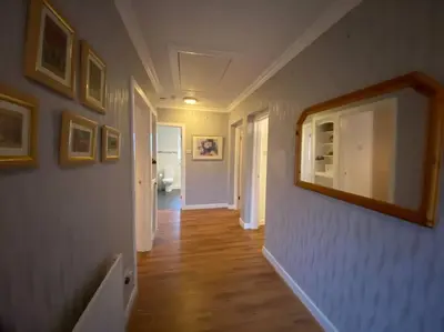 a hallway of a home with a mirror on the wall at Quiet secluded two bedroom bungalow with parking in Cleveleys