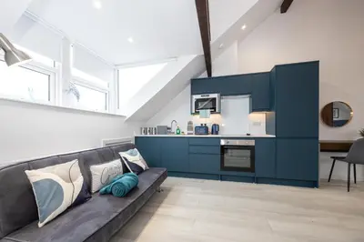 a living room with a couch and a kitchen at Morecambe Bay Free Parking By Beach Front Sea View in Morecambe