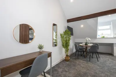 a dining room with a mirror and a table at Morecambe Bay Free Parking By Beach Front Sea View in Morecambe