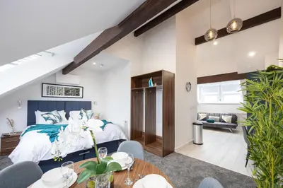 a bedroom with a king sized bed and a living room at Morecambe Bay Free Parking By Beach Front Sea View in Morecambe