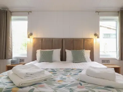 a bedroom with a bed with two towels on it at The Beeches in Ulverston