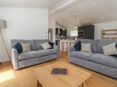 a living room with two couches and a table at Millstream Ridge in Ulverston