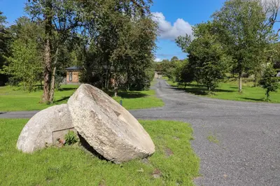a large rock sitting on the side of a road at Millstream Ridge in Ulverston