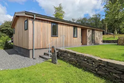 a tiny house with a stone wall at Millstream Ridge in Ulverston
