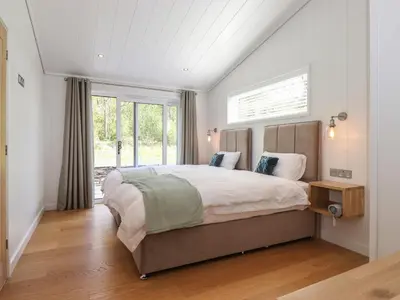 a bedroom with a large bed and a window at Corning Mill View in Ulverston