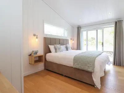 a bedroom with a large bed and a window at Corning Mill View in Ulverston