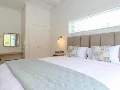 a bedroom with a large white bed with a window at Corning Mill View in Ulverston