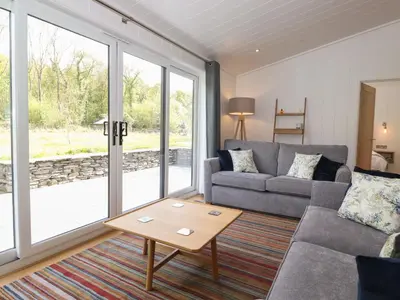 a living room with a couch and a table at Hawthorn Croft in Ulverston