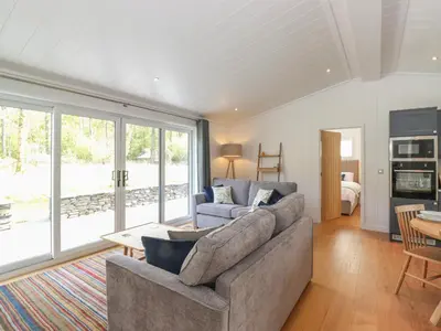 a living room with a couch and a table at Hawthorn Croft in Ulverston
